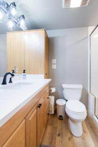 a bathroom with a white toilet and a sink at Perfectly Located 3 Bed 3.5 Bath Beautiful Townhome in Edwards
