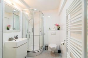 a bathroom with a shower and a toilet and a sink at Flexible SelfCheckIns 71 - Zagreb - New - Center - 50m from the Main Square in Zagreb