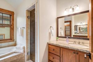 a bathroom with a tub and a sink and a mirror at Cozy Spacious Mountain Home Close To Everything in Minturn +30 photos