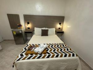a bedroom with a large bed in a room at Hotel la Sierra Riohacha II in Ríohacha