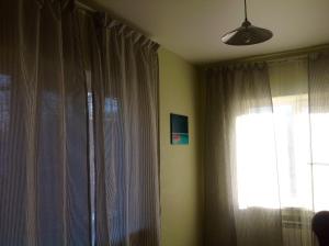 a room with a window, a lamp, and curtains at HZ Hostel in Krasnodar