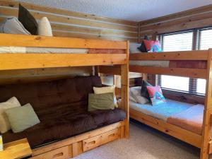 a room with two bunk beds and a couch at Cozy Mountain Cabin W Hot Tub Breathtaking Views in Alma