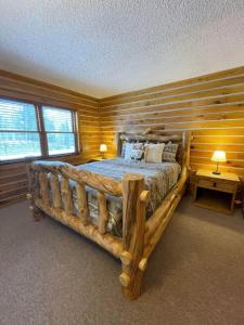 a log cabin bedroom with a large wooden bed at Cozy Mountain Cabin W Hot Tub Breathtaking Views in Alma