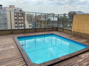 a swimming pool on the roof of a building at Freire Suites in Buenos Aires