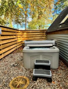 a barbecue grill sitting outside of a building at Macha 3 - Hot Tub-Perth-Pets-Family-Luxury-Cabin in Perth