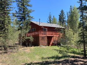 a red house in the middle of a forest at Beautiful Secluded Rocky Mountain Hideaway in Bordenville
