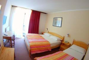 Postel nebo postele na pokoji v ubytování Hotel Canin