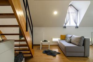 a living room with a couch and a staircase at Flexible SelfCheckIns 71 - Zagreb - New - Center - 50m from the Main Square in Zagreb