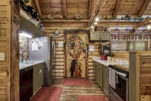 a kitchen with wooden walls and a refrigerator at Creekside Lodge in Sevierville +63 photos