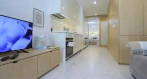 a large white kitchen with a flat screen tv at Lubina del Sol beachfront in Sitio de Calahonda +6 photos