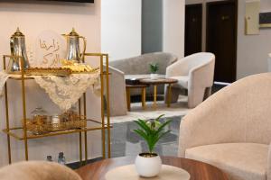 a living room with gold furniture and a table at فندق فيوليت الفندقية Violet Hotel in Yanbu +64 photos