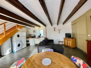 a living room with a couch and a table at Theven Plages in Santec