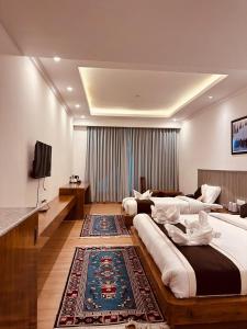 a large bedroom with two beds and a television at The Shava Ladakh in Leh +20 photos