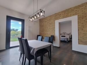 a dining room with a white table and chairs at Borgo Ragnitill in Lanciano
