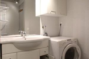a bathroom with a sink and a washing machine at Maison 3 pièces 4 couchages Dolus d'Oléron DDO000-176 in Dolus d'Oléron