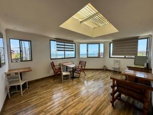 an empty room with tables and chairs and windows at Hostal Iquique Vivar 1770 in Iquique