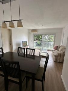 a dining room and living room with a table and chairs at Alberti Apartament in San Isidro