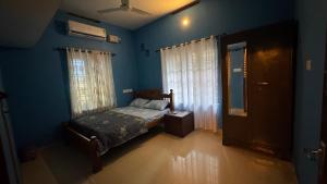 Postel nebo postele na pokoji v ubytování Souparnika Homestay Varkala