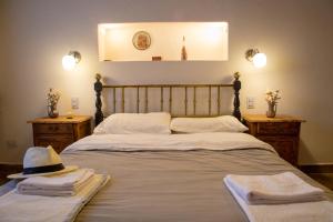 a bedroom with a bed with a hat on it at Sentido Huacalera - Guest House in Tilcara