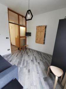 a living room with a couch and a table and a door at Casa Amorì in Castel di Sangro