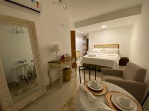 a hotel room with a bed and a mirror at Pousada Camarote Itaipu in Niterói