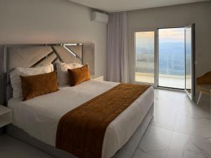 a bedroom with a large bed with a large window at Oca Douro Valley Hotel and Spa in Sambade +21 photos