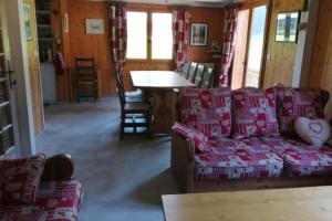 a living room with a couch and a table at Chalet Phidel - 11 personnes in Bernex