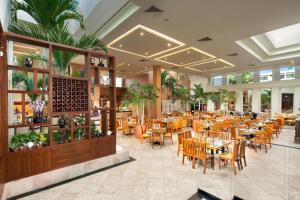 a restaurant with tables and chairs in a room at The Grand Oasis Cancun - All Inclusive in Cancún