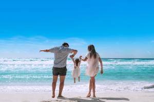 a family of three standing on the beach at Grand Oasis Tulum Riviera - All Inclusive in Akumal +37 photos