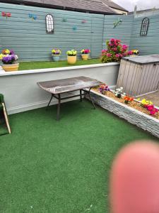a patio with a table and some flowers and plants at 17 DB property in Wexford