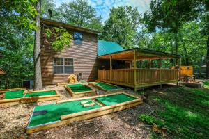 a house with a deck with four mini golf courses at S'more Family Fun in Sevierville