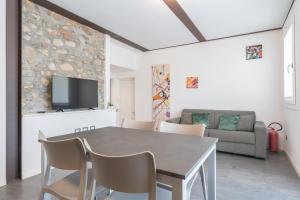 a dining room with a table and chairs at Residence La Corte di San Rocco in Cremeno