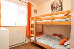 a bedroom with two bunk beds and a window at Finest Retreats - Llys Llewellyn in Kinmel Bay