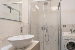 a bathroom with a sink and a washing machine at Residence La Corte di San Rocco in Cremeno +65 photos