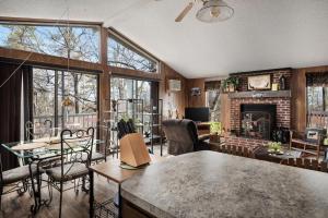 a living room with a table and a fireplace at Zen Vibe w Fireplace Grill Deck & Screened Porch in Hedgesville +39 photos