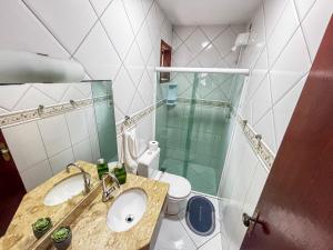 a bathroom with a sink and a toilet and a glass shower at Mar Y Suites in Cabo Frio +46 photos