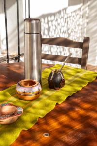 a table with a bowl and a mortar and pestle on a napkin at Sentido Huacalera - Guest House in Tilcara +41 photos