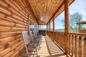 a porch of a cabin with chairs on it at Blue Bear Splash in Pigeon Forge