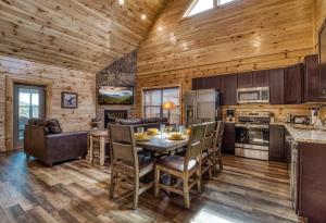 a kitchen and dining room with a table and chairs at Blue Bear Splash in Pigeon Forge