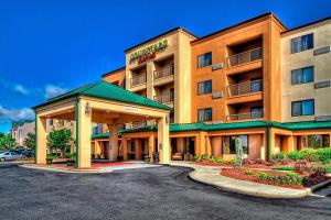 a hotel with a parking lot in front of it at Courtyard by Marriott Burlington in Burlington