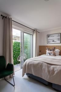 a bedroom with a bed and a sliding glass door at Beachfront Kite House No 1 Shaapenzicht 1 in Langebaan