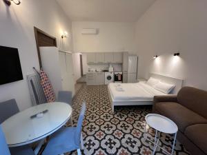 a small living room with a couch and a table at The Old Mint Residence 4 in Valletta