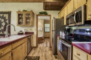 a kitchen with stainless steel appliances and wooden cabinets at Reflections in Sevierville