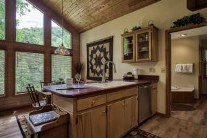 a kitchen with a sink and some windows at Reflections in Sevierville