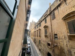 a view of an alley from the window of a building at The Old Mint Residence 4 in Valletta