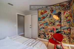 a bedroom with a superhero mural on the wall at 3BD Townhouse , Themed , 10 min to Disney , Gated in Kissimmee