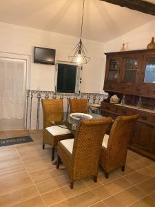 a dining room with a table and chairs at Casinha Amarela in Cabeção