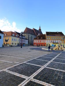 an empty square in a city with buildings at RAD Residence in Braşov
