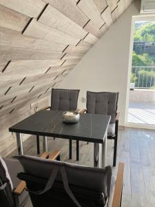 a dining room with a black table and chairs at Ira 28 in Sandanski