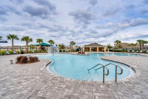 a swimming pool at a resort with palm trees at Davenport Home w/ Pool Access & Patio! in Davenport